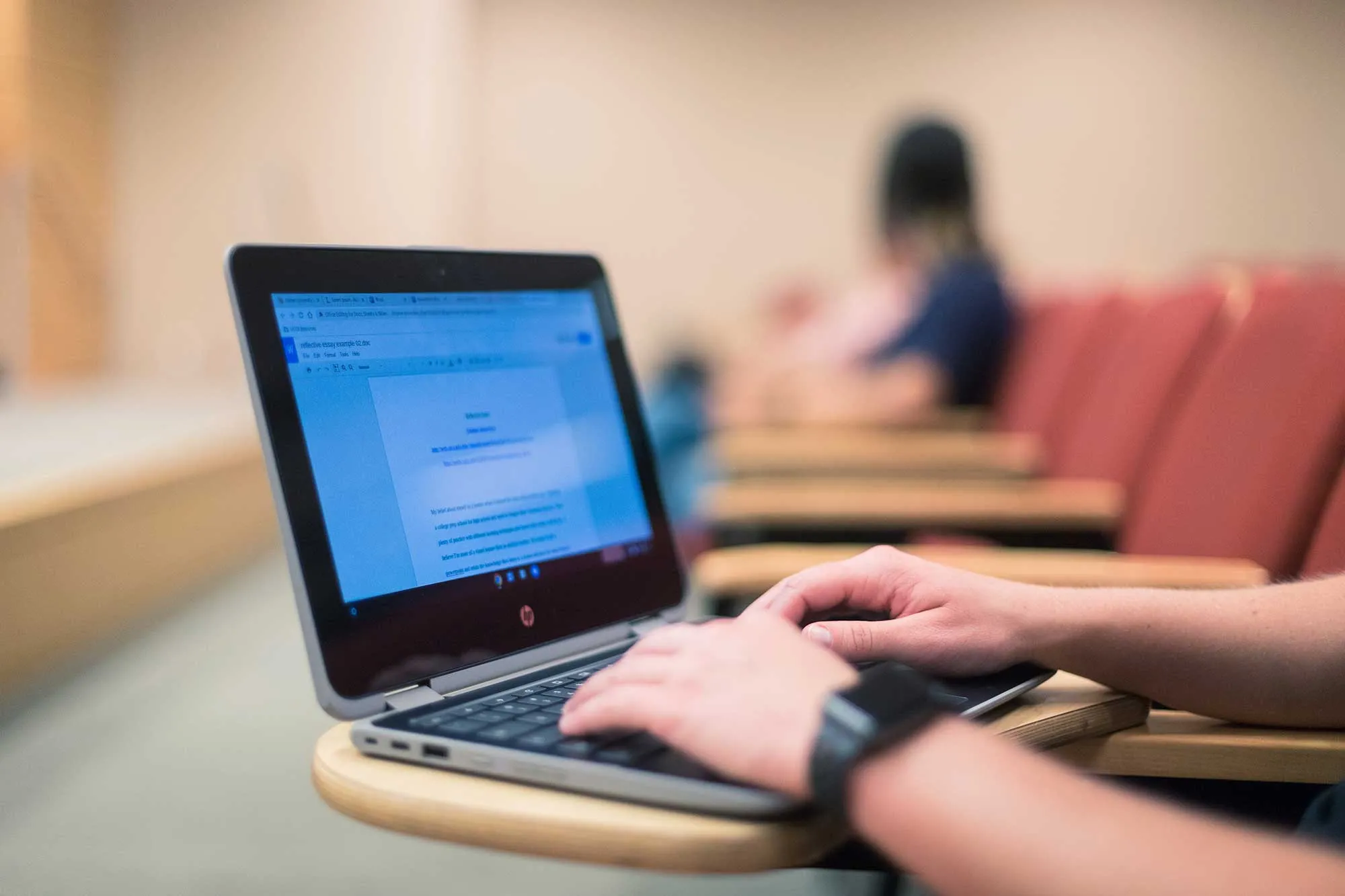 Typing on laptop in classroom